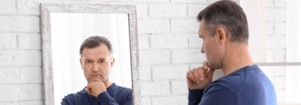 man looking into a mirror