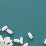 Rx bottle with pills spilling out.
